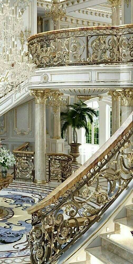 Ornate staircase with gold railing