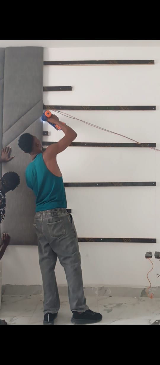 Team member installing wall feature