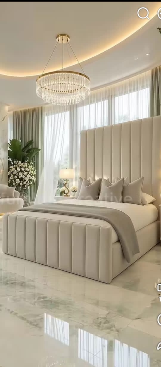 Bedroom with upholstered headboard and warm lighting